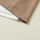 Close-up of the hem of the Shewin Khaki Color Block Exposed Seam Long Sleeve Top, showcasing the stitching detail and a white inner layer. The fabric, known for its versatile khaki color, lies flat on a light-colored surface.