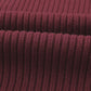 Close-up of ribbed, dark red fabric folded over itself from Shewin's Patch Pocket Ribbed Knit Short Sleeve Sweater, evoking coziness.