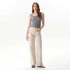 A person wearing a grey tank top and Faire Off White Mid Rise Straight Pants featuring front patch pockets.