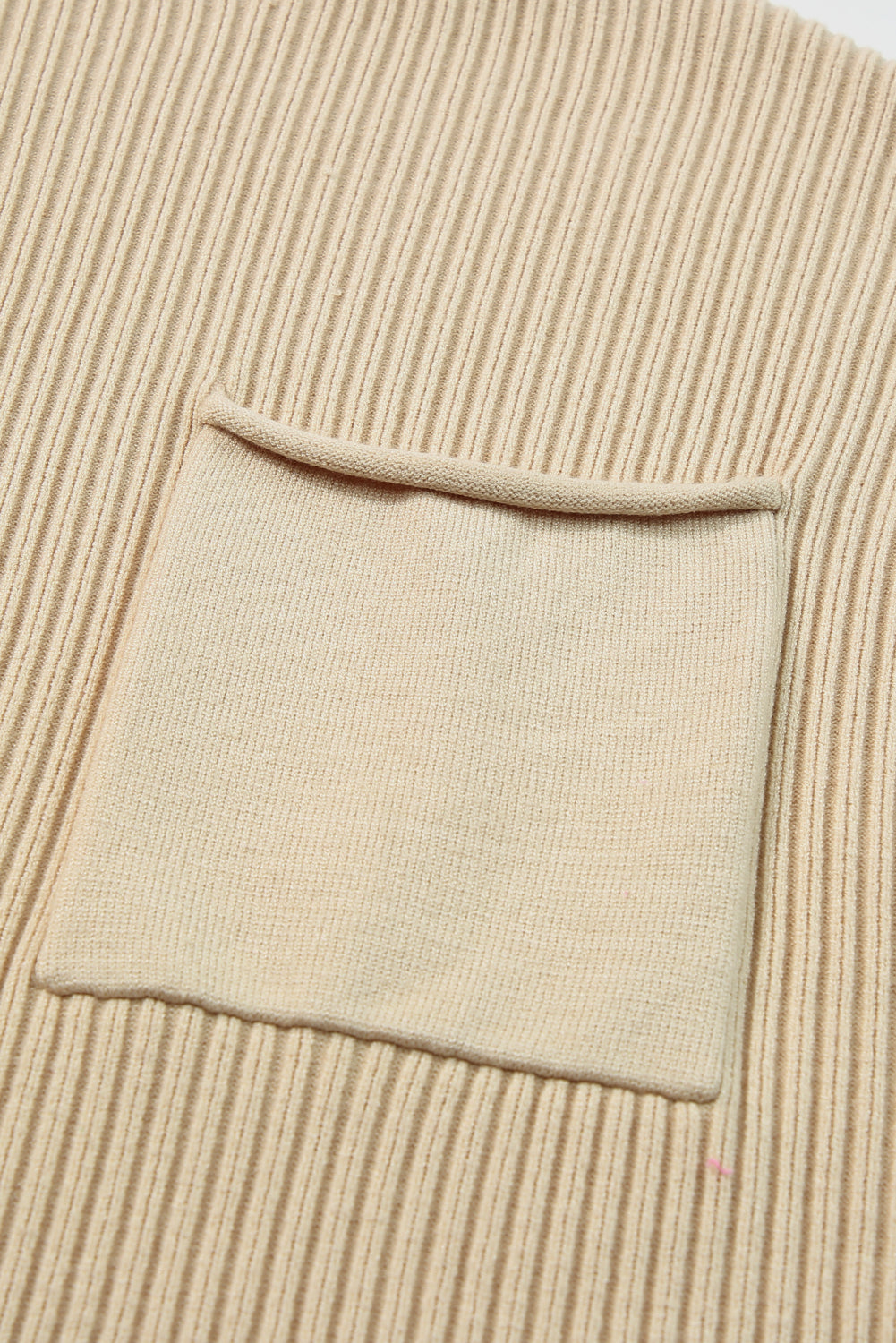 Close-up of Shewin's beige Patch Pocket Ribbed Knit Short Sleeve Sweater, ideal for transitional weather.