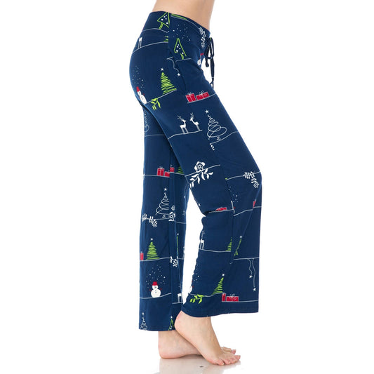 A person stands barefoot on a white background wearing Leggings Depot's Buttery Soft Print Pajama Pants with Christmas prints, an elastic waistband, and functional pockets.