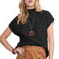 A woman poses confidently in a black Shewin Patch Pocket Ribbed Knit Short Sleeve Sweater and a brown skirt, ready for transitional weather.