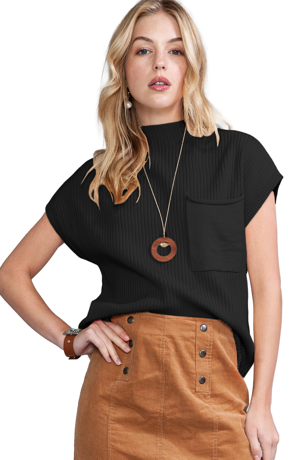 A woman poses confidently in a black Shewin Patch Pocket Ribbed Knit Short Sleeve Sweater and a brown skirt, ready for transitional weather.