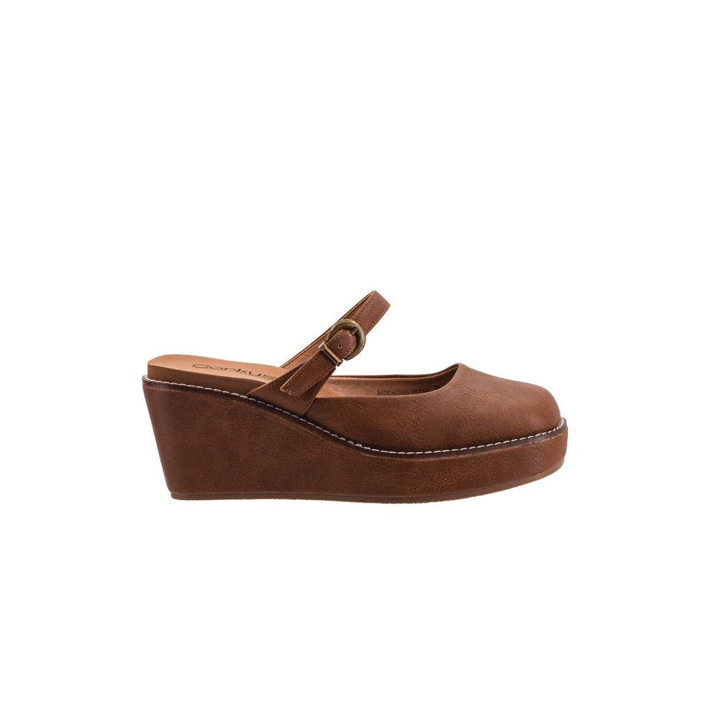 The Me Time Wedge by CORKY’S FOOTWEAR INC is a women’s Mary Jane shoe featuring a round toe, ankle strap with buckle, white stitching, and closed back—shown in side profile on a white background—making it an ideal choice for those seeking comfortable wedge sandals with timeless style.
