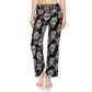 A person models Leggings Depot Buttery Soft Print Pajama Pants featuring a colorful sugar skulls pattern and elastic waistband, standing barefoot against a white background.