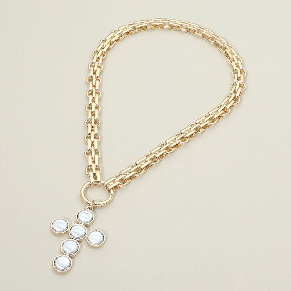 Sensibling Corp.’s “Pearl Cross Charm Pendant Chunky Chain Statement Necklace” is shown on a plain light background, featuring a gold chain and a cross-shaped textured pendant adorned with six round white stones.