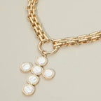 Introducing the Sensibling Corp. Pearl Cross Charm Pendant Chunky Chain Statement Necklace, showcasing a bold gold chain with a textured cross pendant adorned with six pearl-like circles for an elegant touch.