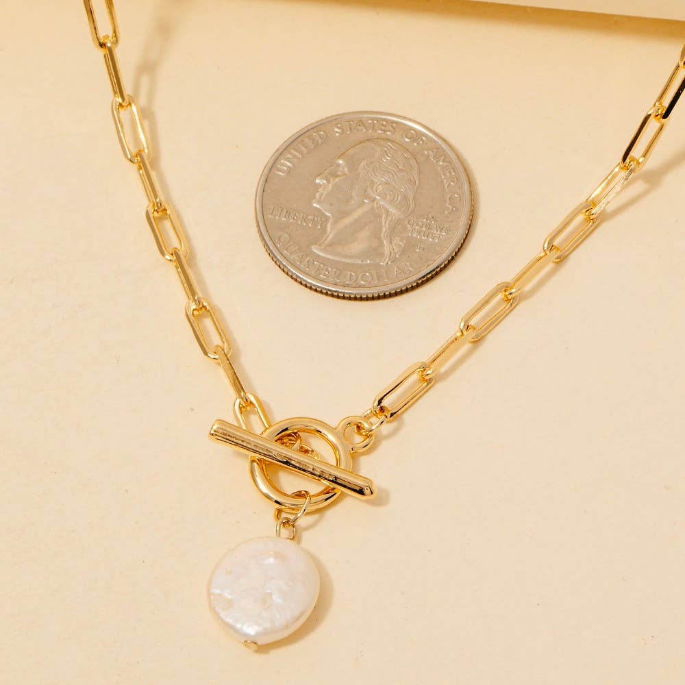 The Anarchy Street Toggle Chain Link Disc Pearl Charm Necklace is displayed beside a quarter for size comparison.