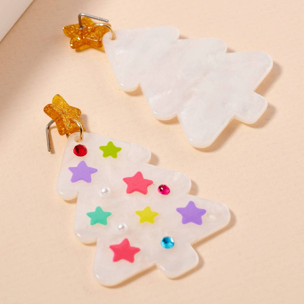 Add a festive touch to your holiday look with the Lilla Haven Glittery Christmas Tree Drop Earrings. This playful pair features two marbled white, acrylic tree-shaped earrings—one adorned with colorful stars and gems and the other left simple for contrast. Each is topped with a golden star, making these Holiday Acrylic Earrings a sparkling statement piece for any seasonal ensemble.
