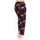 A person stands barefoot, shown from the back against a white background, wearing Leggings Depot Buttery Soft Print Pajama Pants in black with red floral and white patterns.