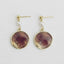 A pair of Ellemadera Purple Enamel Geometric Drop Earrings displayed on a light background.