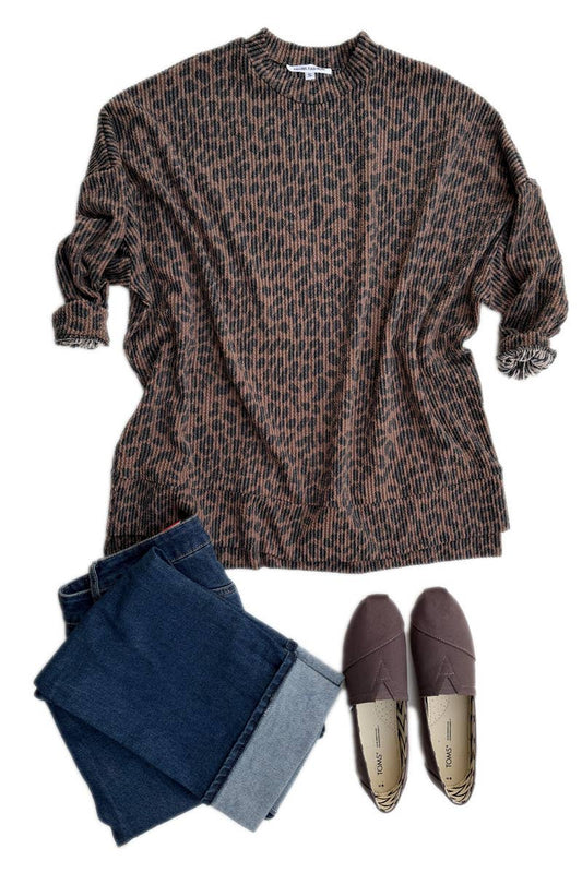 The Urban Ribbed Long Sleeve Leopard Sweatshirt by 24-Hrs Fashion is styled with cuffed blue jeans and brown slip-ons on a white backdrop—ideal for layering and casual looks.