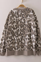The very J Leopard Printed Crew Neck Sweatshirt, featuring a relaxed fit and a brown, beige, and white leopard print pattern, is displayed on a hanger against a plain background.