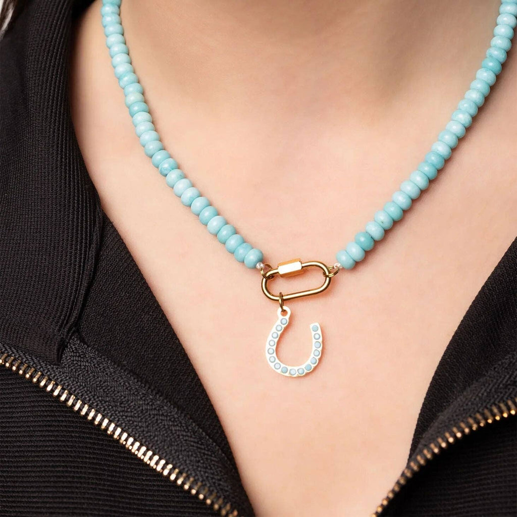 A person wearing the WJW Stainless Steel Turquoise Chunky Bead Carabiner Necklace over a black zippered garment.