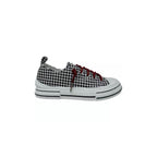 The Aman Tailor Houndstooth Sneaker by VERY G features a bold black and white houndstooth pattern, accented with vibrant red rhinestone shoelaces, a crisp white sole, and a distinct black stripe detail. Displayed in side profile against a white background, this unmistakable statement sneaker offers standout style at every step.