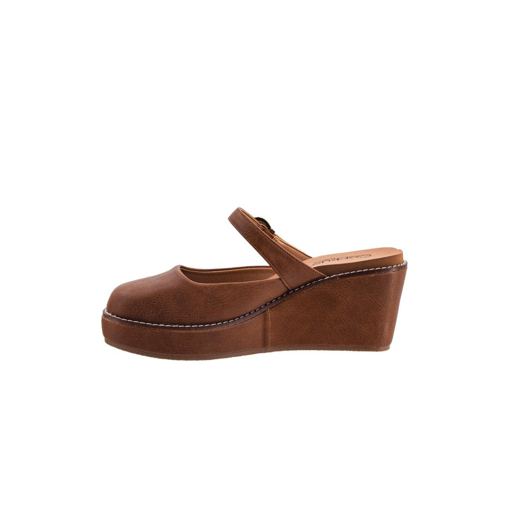 The Me Time Wedge by CORKY’S FOOTWEAR INC is a stylish auburn women’s Mary Jane wedge sandal featuring a closed toe and single strap, shown in profile on a white background.