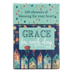 The Box of Blessings Grace for Each Day from Christian Art Gifts features charming illustrations of houses and raindrops, labeled "GRACE for each day" and "100 showers of blessing for your heart." Inside, you'll discover Scripture cards filled with inspirational verses to encourage your spirit each day.