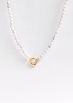 Introducing the WJW Semi Precious Natural Stone Charm Keeper Necklace, featuring round white beads and a refined 18K Gold PVD Coated circular clasp, beautifully showcased against a white background.