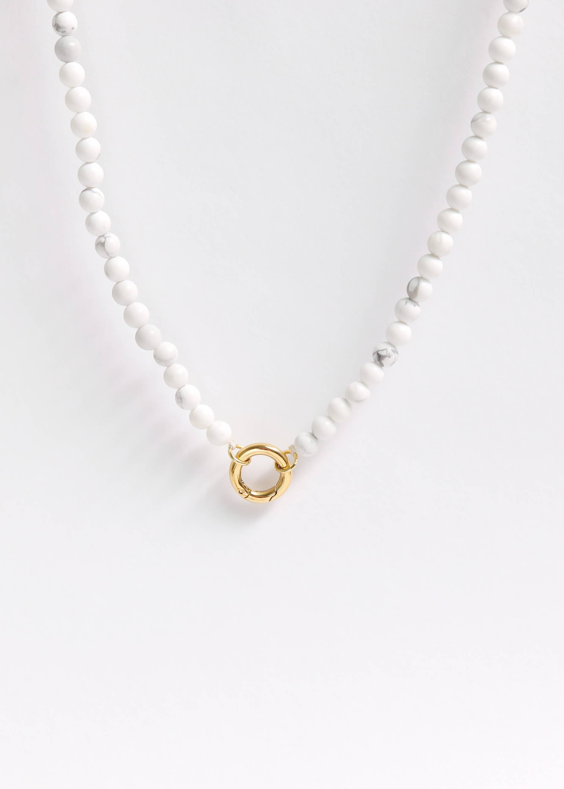 Introducing the WJW Semi Precious Natural Stone Charm Keeper Necklace, featuring round white beads and a refined 18K Gold PVD Coated circular clasp, beautifully showcased against a white background.