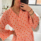 A person in a Shewin Orange Floral Button V Neck Bell Sleeve Mini Dress takes a mirror selfie in a room filled with flowers and sunlight streaming through the window.