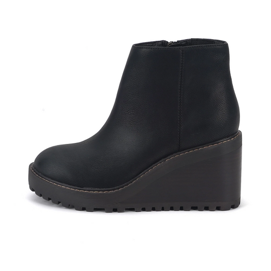 The Alexis Wedge Boot in Black by Yellow Box boasts a faux leather design with a textured wedge heel and a convenient side zipper, elegantly presented from the side on a white backdrop.