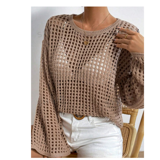 A person is embracing a cozy yet chic look by wearing the FASHION GO Crochet Pull Over Long Bell Sleeve Sweater in Caramel over a white top, paired with crisp white pants.