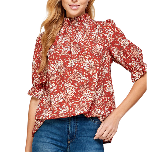 A person is wearing the FASHION GO Floral Print Ruffled Neck Puff Short Sleeve Top in Marsala, paired with blue jeans.