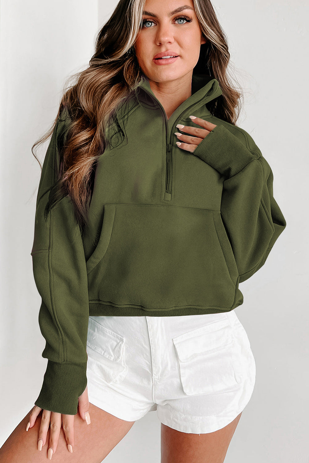 A person with long hair wears the Shewin Gray Zip Up Stand Collar Ribbed Thumbhole Sleeve Sweatshirt and white shorts against a plain background.