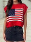 A person is wearing the 4th of July Stars and Stripes Dolman Short Sleeve Sweater by 1 the Woman with a black studded denim skirt, standing outdoors.