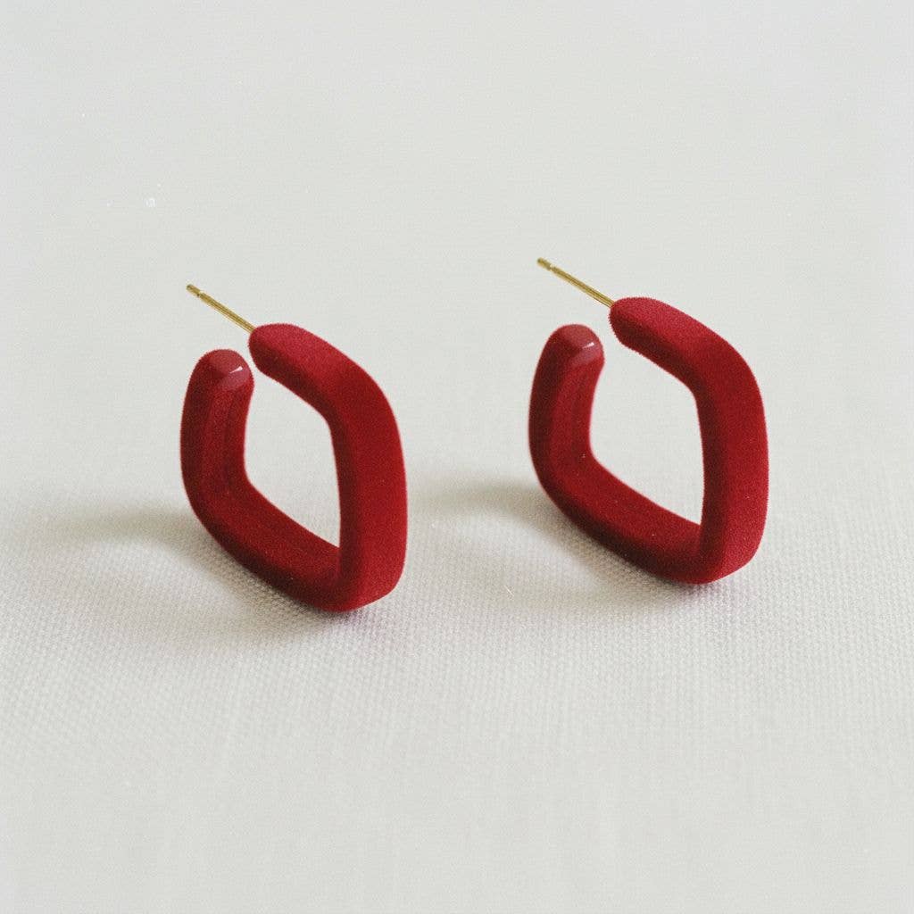 A pair of Retro Geometric Drop Earrings with a bold design from Ellemadera are displayed on a white background.