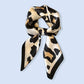 ACCITY Leopard Print Satin Square Scarf, Hair Wrap—a chic accessory featuring a beige background with black and brown leopard print, styled in a loose knot, perfect for elevating any outfit.