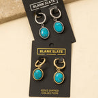 Two pairs of Oval Turquoise Stone Drop Earrings by Anarchy Street—one in silver-tone, one in gold-tone—add a chic pop of color to your collection. Each pair features an oval turquoise stone set in metal drop settings.