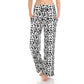 A person wears Leggings Depot Buttery Soft Print Pajama Pants in black leopard print, featuring an elastic waistband, standing barefoot with hands in pockets.