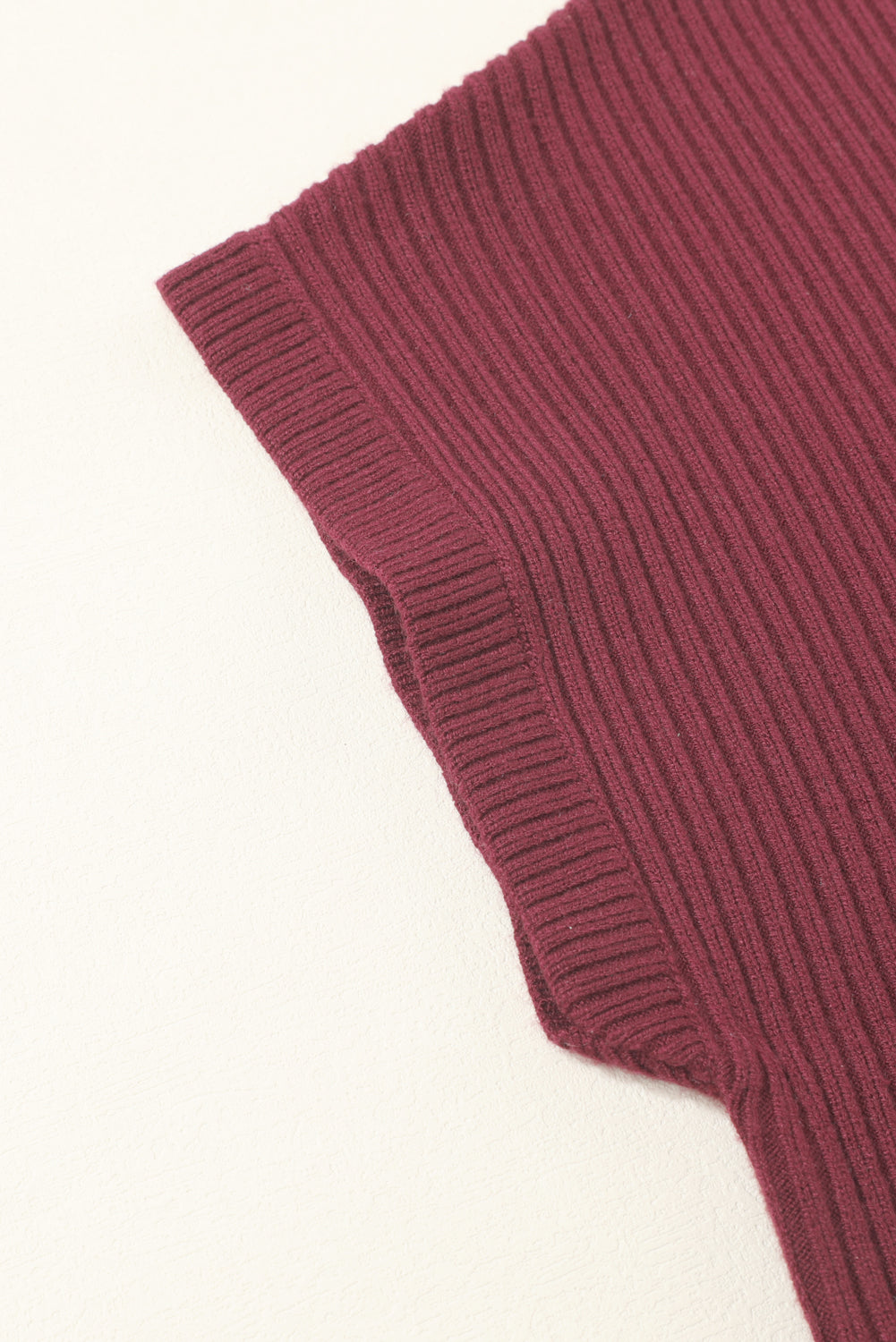 Close-up of the Shewin Patch Pocket Ribbed Knit Short Sleeve Sweater in burgundy showcases its texture and detail, ideal for transitional weather with a comfortable fit.