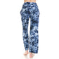 A person stands barefoot, facing away, wearing Leggings Depot’s Buttery Soft Print Pajama Pants with a blue and white tie-dye design and an elastic waistband against a white background.
