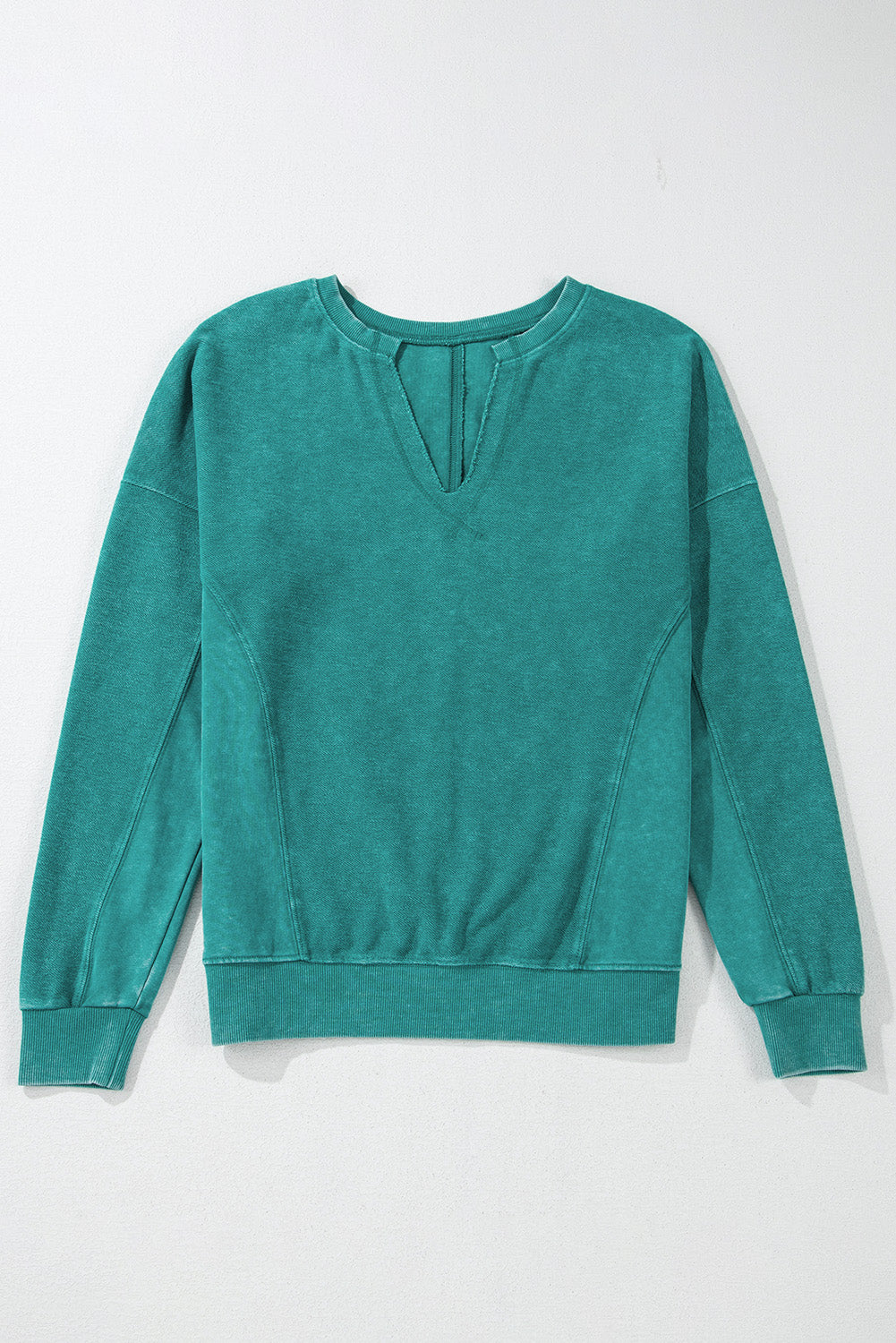 The Shewin Notched Neck Exposed Seam Drop Shoulder Sweatshirt, featuring a teal green color and crafted from premium fabric, is displayed against a plain background.