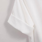 Close-up of the FASHION GO White Relaxed Fit Short Sleeve Blouse, showcasing its neatly folded cuff detail against a light background.