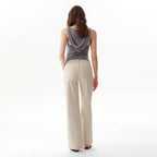 Back view of a person wearing Faire Off White Mid Rise Straight Pants and a grey hooded tank top.