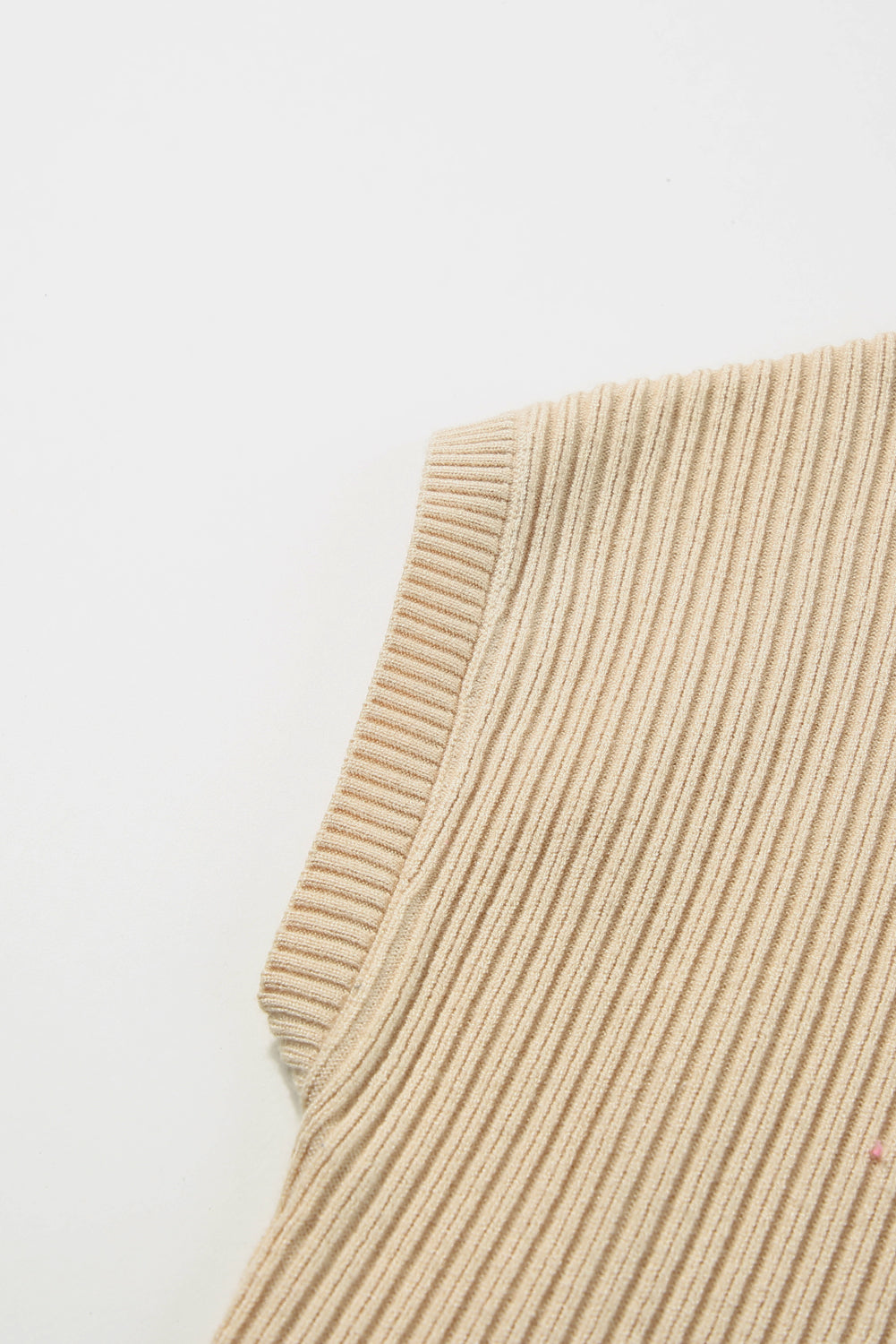 Against a white backdrop, the Shewin Patch Pocket Ribbed Knit Short Sleeve Sweater in beige showcases its ribbed texture and visible seam, making it an ideal layering piece for transitional weather.