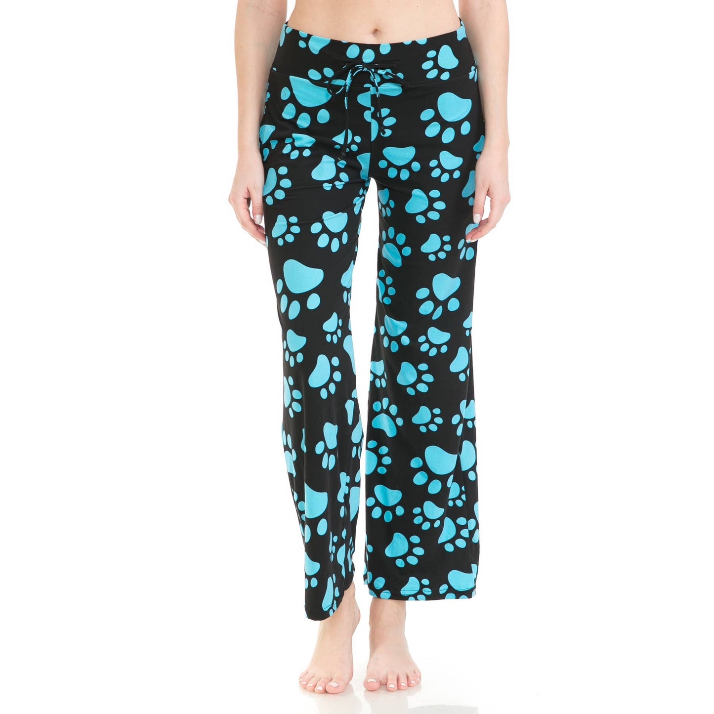 A person wears Leggings Depot’s Buttery Soft Print Pajama Pants featuring blue paw prints and an elastic waistband, standing barefoot against a white background.
