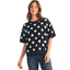 A woman modeling the FASHION GO Large Polka Dots Short Sleeve Sweater, featuring a black and white polka dot design, paired with dark blue jeans against a white background—an ideal women’s transitional sweater for any season.