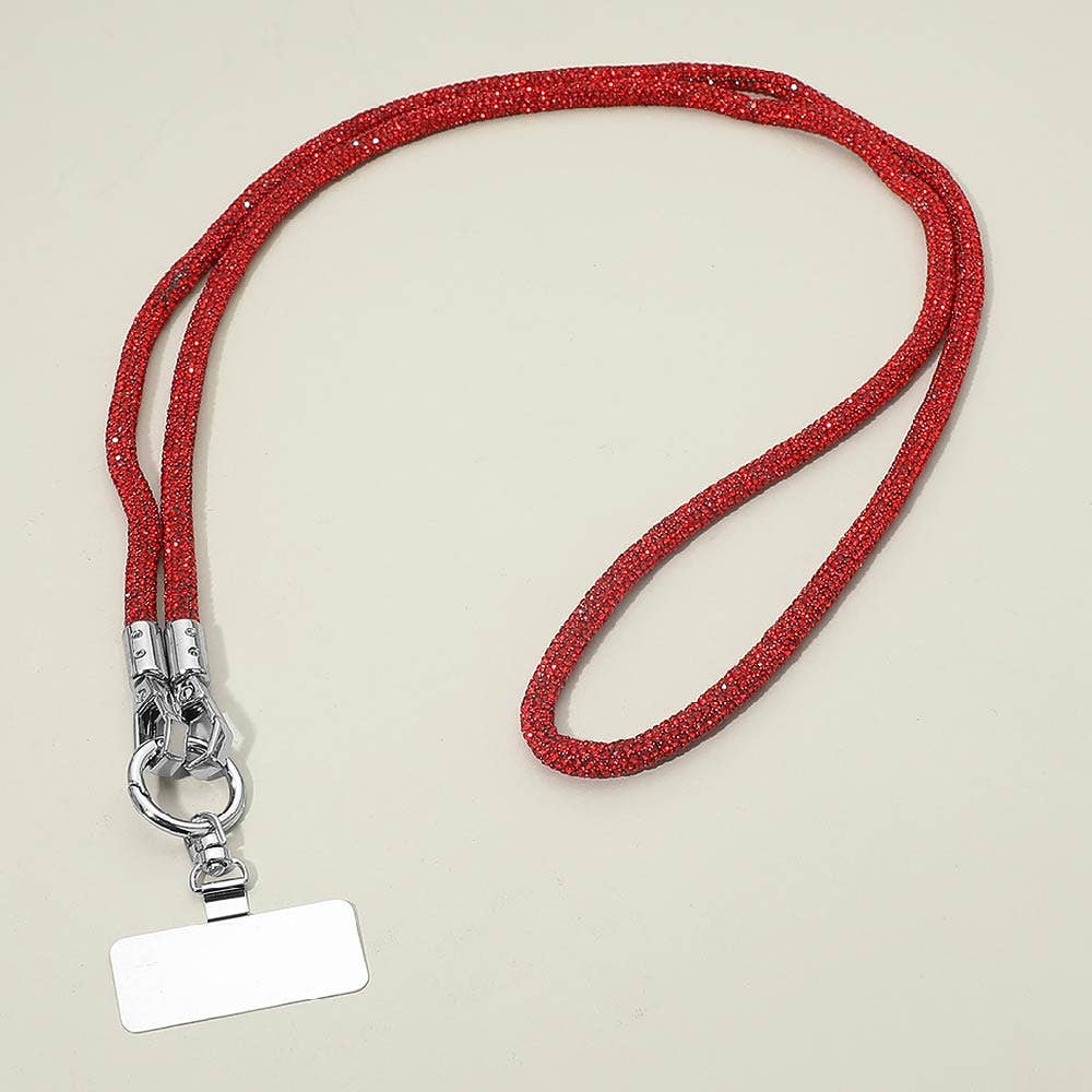 The Sensibling Corp. Rhinestone Phone Lanyard Necklace, shown in red with a sparkly rhinestone strap, a silver metal clasp, and a blank rectangular name tag, is displayed against a plain, light-colored background.