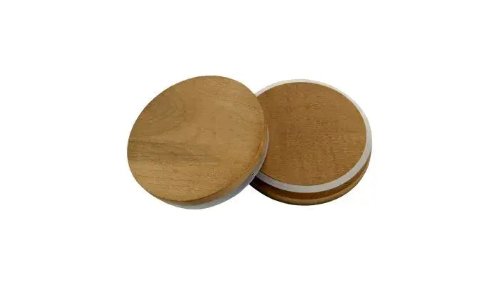 Two round wooden coasters, recalling the warmth of a 20oz, 3 Wick Soy Wax Candle by Stephanie Henry Candle Company, lie side by side on a white background.