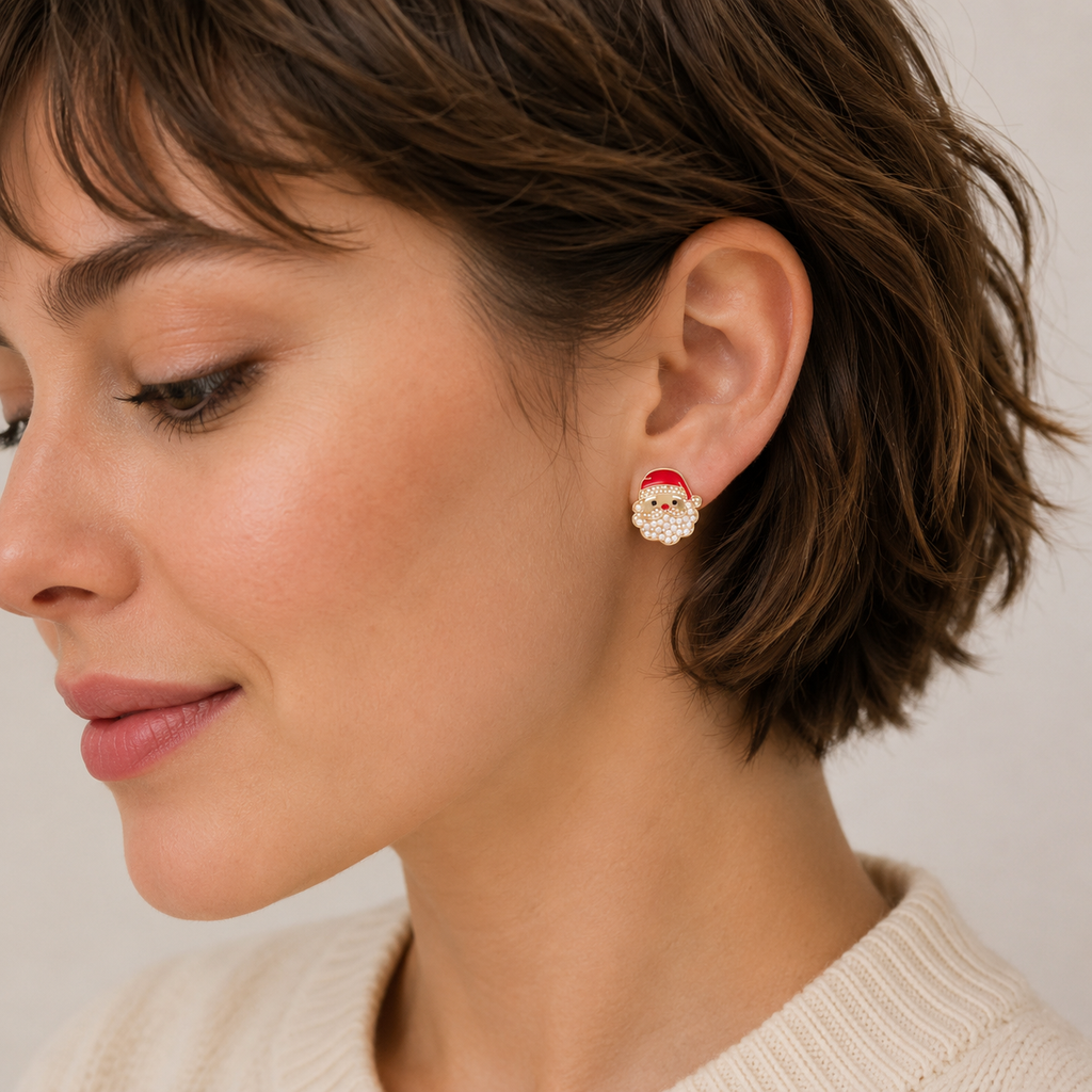 A woman with short brown hair wears a cream sweater and a Lilla Haven Pearl Santa Claus Stud Earring on her left ear, shown in profile against a neutral background—an elegant Christmas holiday accessory from the Pearl Santa Claus Stud Earrings collection by Lilla Haven.