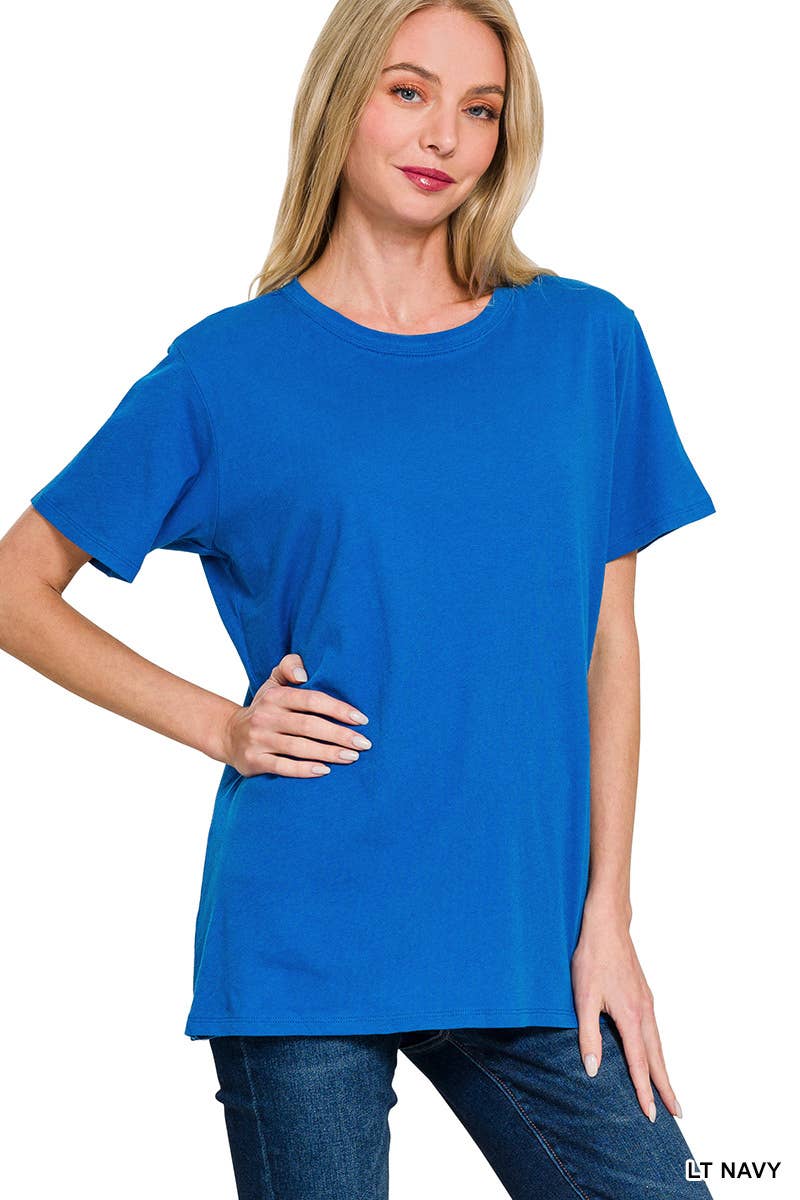 A woman poses against a white background wearing the 42POPS Short Sleeve Basic Tee in blue, paired with jeans and standing with one hand on her hip.