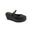 The Me Time Wedge by CORKY’S FOOTWEAR INC features a black wedge-heeled Mary Jane design with a gold buckle strap, brown stitching around the sole, and the Corkys Footwear logo on the insole. These black wedges for women offer classic style combined with all-day comfort, making them an ideal choice for anyone seeking comfortable wedge sandals.