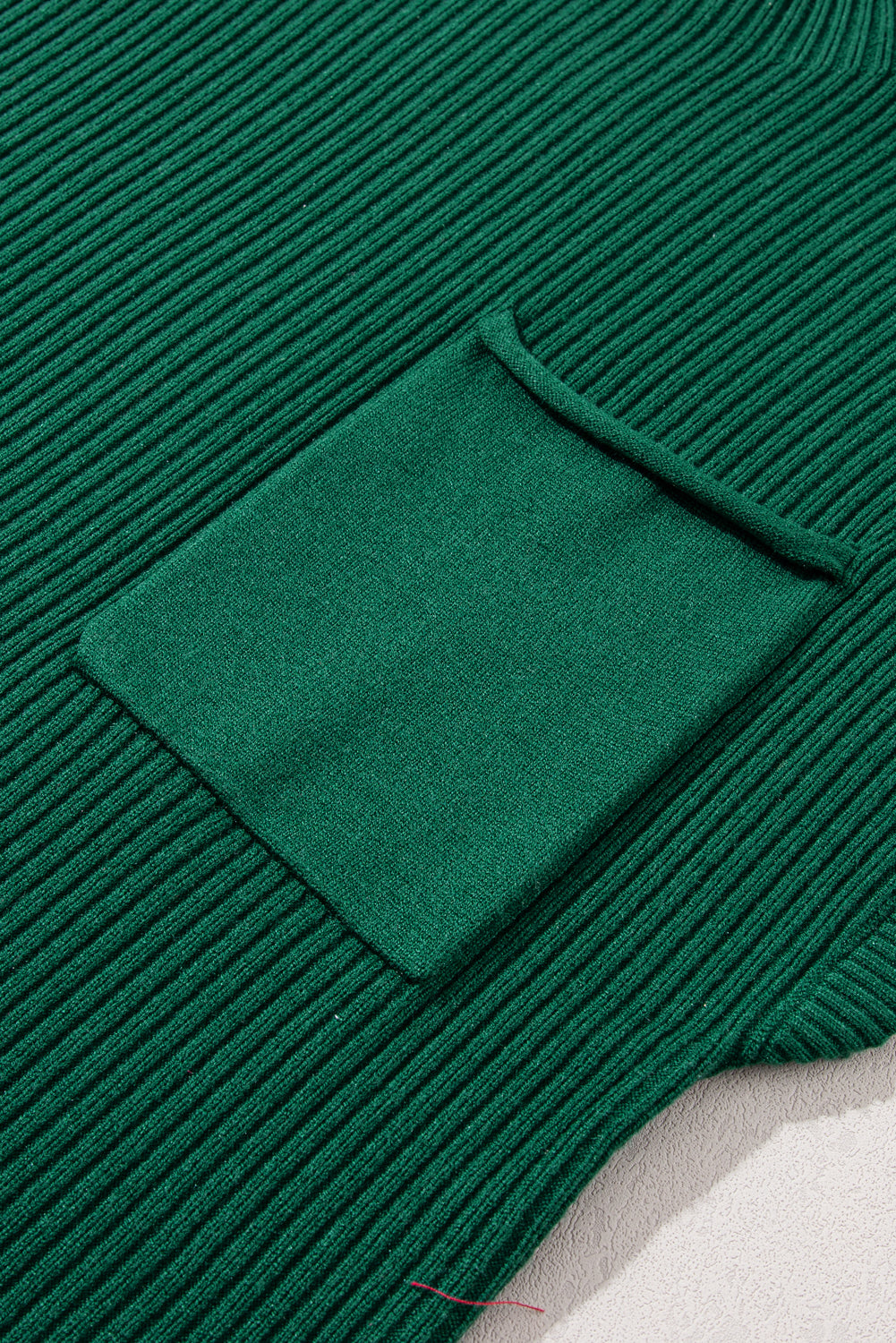 The Shewin Patch Pocket Ribbed Knit Short Sleeve Sweater is ideal for transitional weather, featuring a cozy green knit design with a small square pocket.