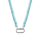 A close-up of the WJW Stainless Steel Turquoise Chunky Bead Carabiner Necklace, featuring round light blue beads and a stainless steel carabiner clasp in the center.
