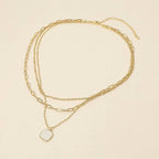 Introducing the Sensibling Corp. 18K Gold Dipped Square Pendant Accent Mixed Paperclip Chain Layered Necklace, featuring two elegant chains: one adorned with a square pendant, the other a simple, classic strand. Both are secured with an adjustable extender clasp for the perfect fit.