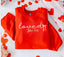 The Festivitees Loved John 3:16 Sweatshirt features "loved" in white text with red and pink hearts—a stylish unisex Christian faith piece.